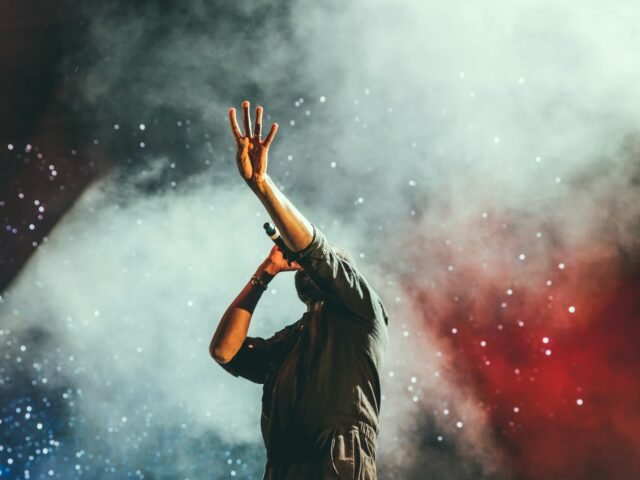 Singer performing live on stage with a microphone
